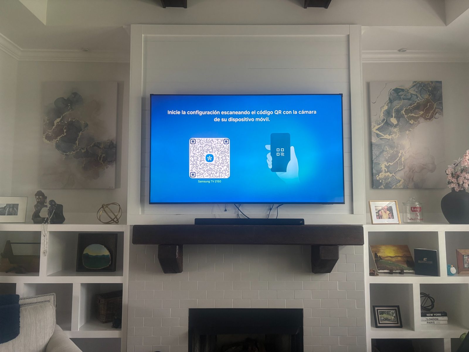 TV mounted above fireplace with clean finished wall setup.
